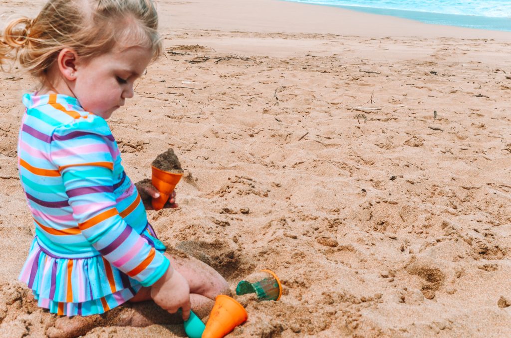 one of the tips for taking baby to the beach for the first time is covering their skin up