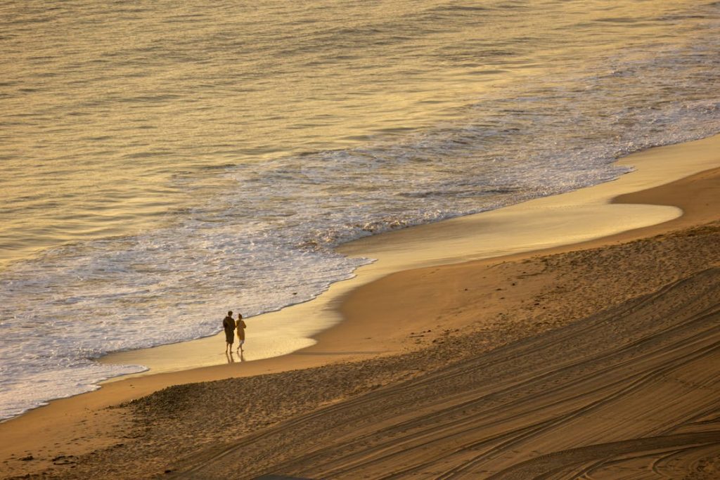 sunset walk on an east coast beach, one of the best us beaches to visit in july